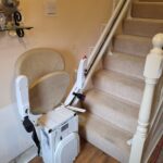 Reconditioned Stairlifts Ireland. Cream carpet with a white stairlift and cream padding.