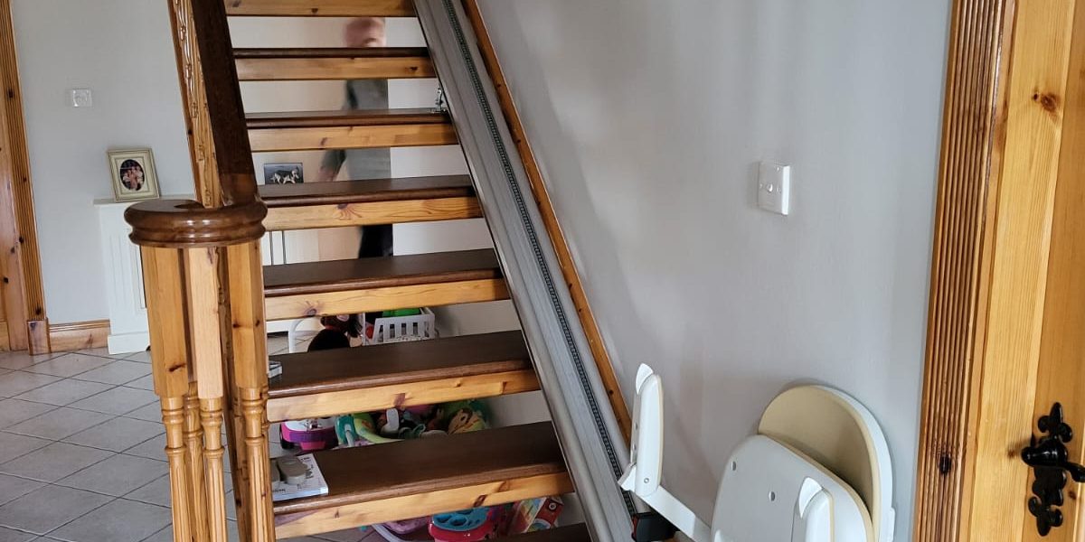 Straight stairlift on wooden staircase